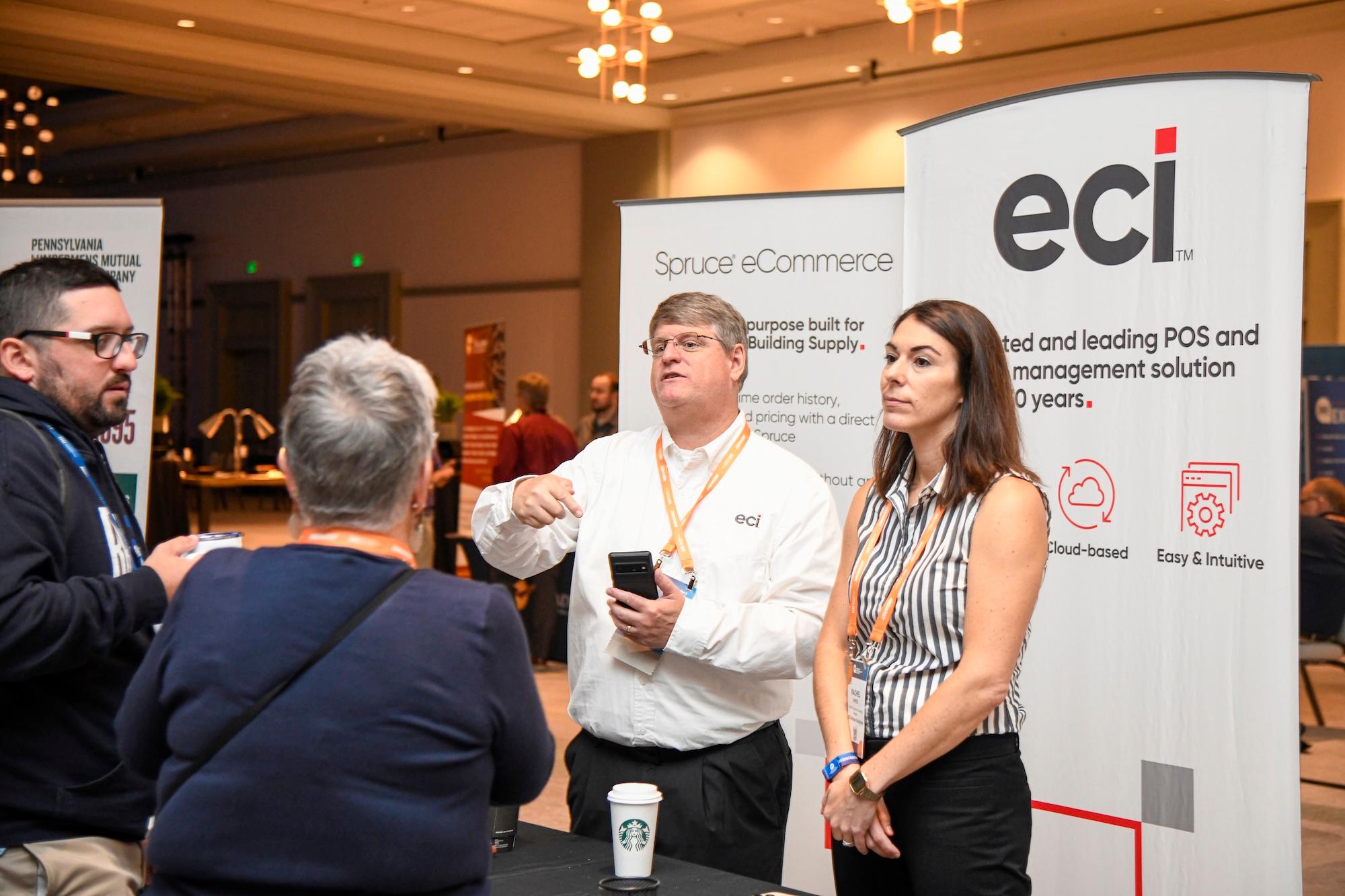 ECI Solution sales representatives talk with retailers.